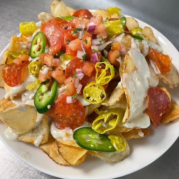 Dunmire’s on the Lakes' loaded potato chips with pepperoni, pico de gallo, jalapeños, and white sauce.