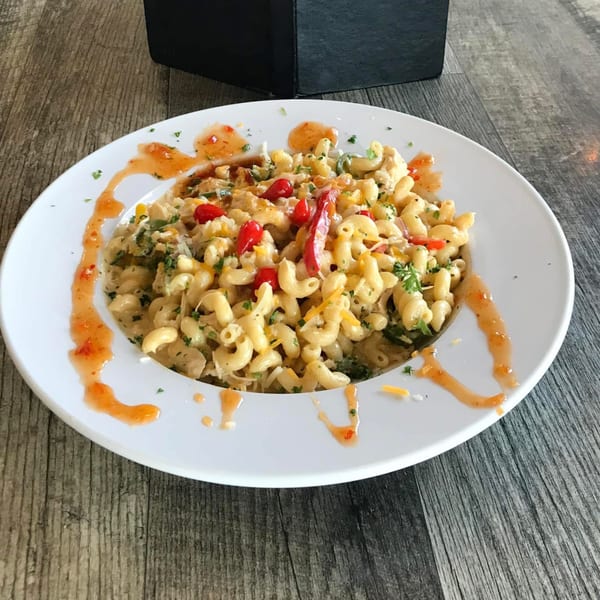 Dunmire's on the Lakes' mac and cheese, topped with red peppers, herbs, and a sweet chili drizzle.